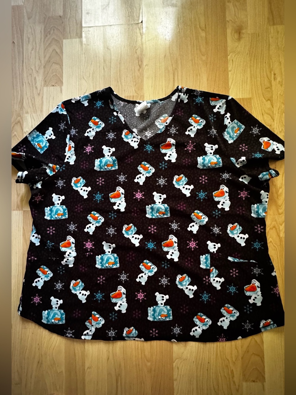 FROZEN’s Olaf Scrub Top.  Perfect anytime of the year and during winter.